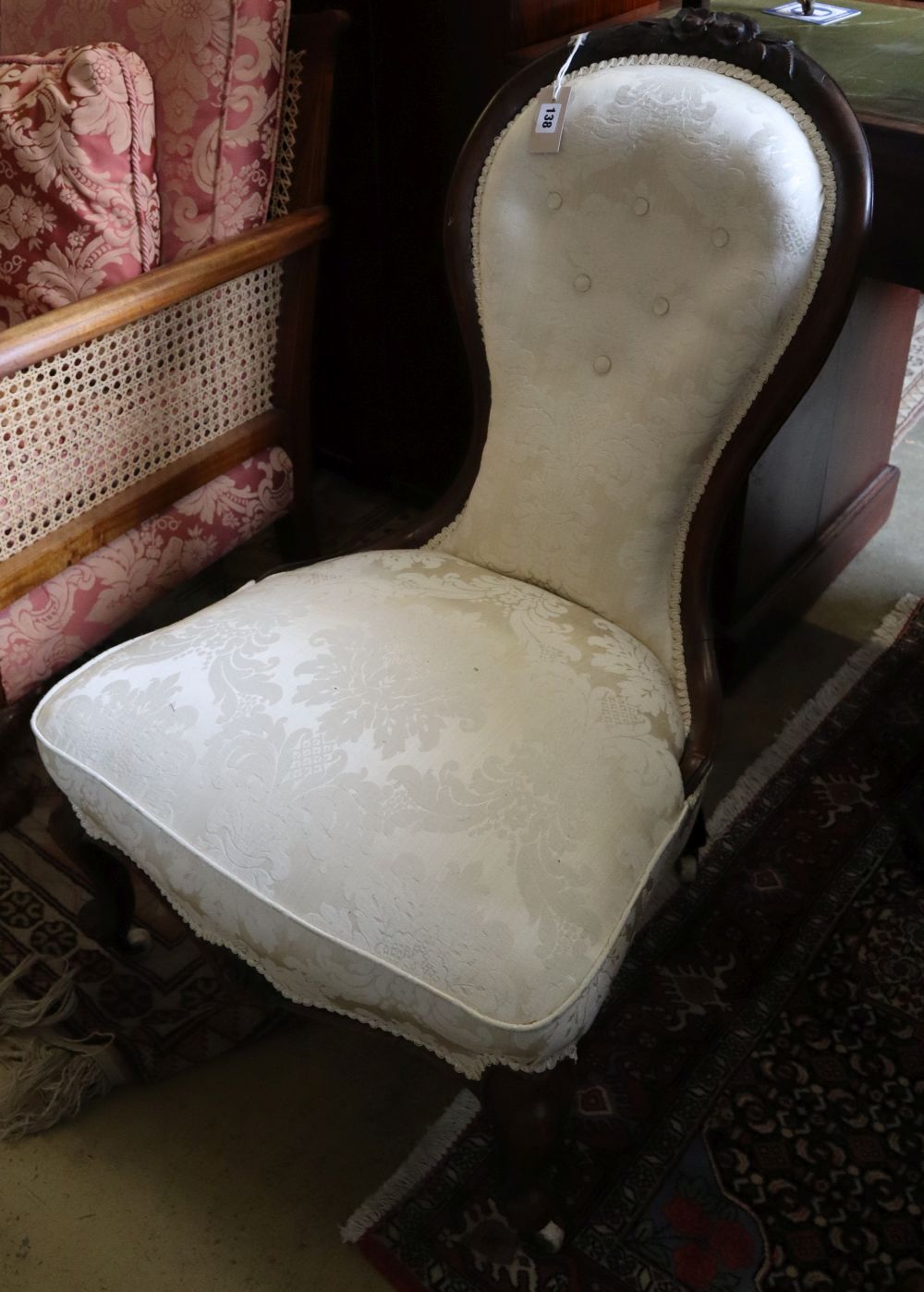A Victorian carved walnut nursing chair